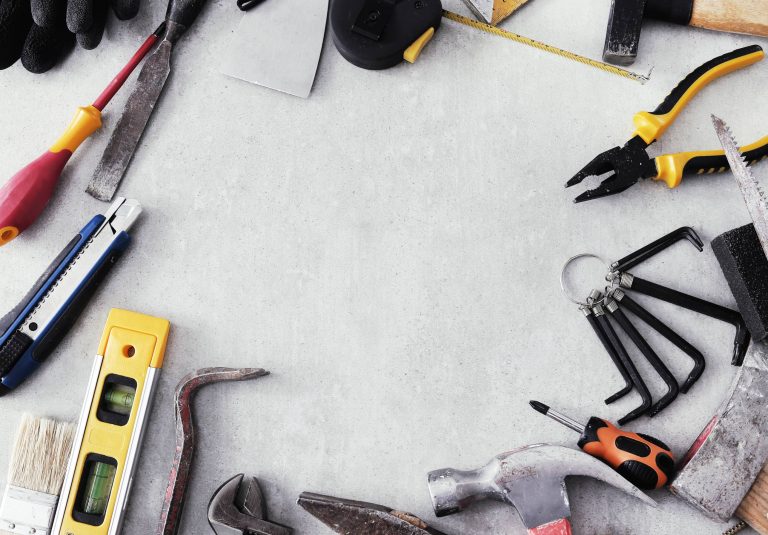Handyman tools including a drill bit, spirit level, pliers and hammer